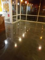 Black dyed concrete floor and polished with a sealer on top.