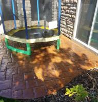 Stamped concrete was rejuvinated with stain and sealer on this outdoor patio.