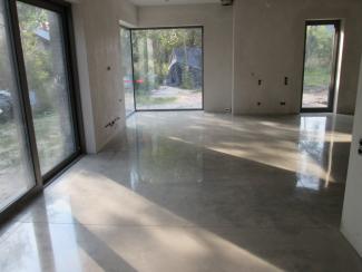 A residential basement floor is refinished with a high gloss polish of it's concrete.